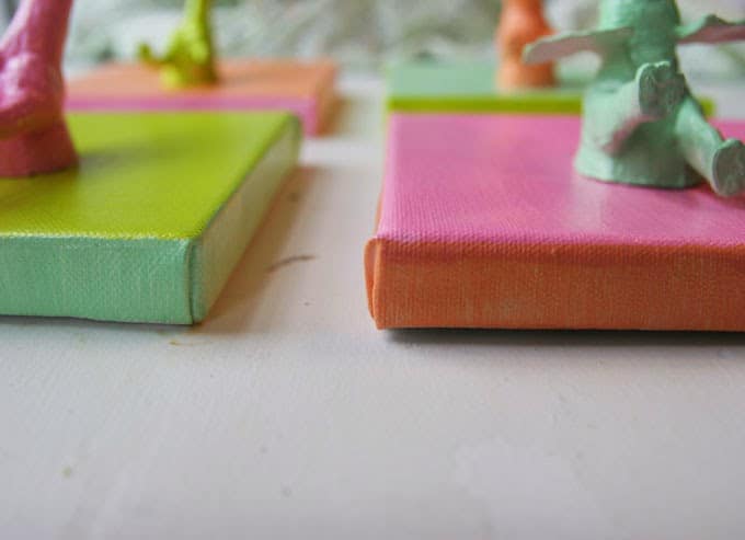 For some easy DIY art, make these mini animal canvases out of plastic toys, super glue and paint! They are so funky and unique for a nursery or child's bedroom!