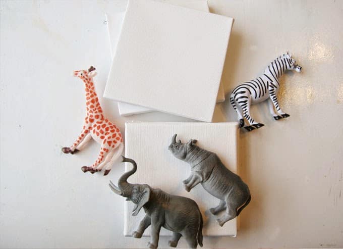 For some easy DIY art, make these mini animal canvases out of plastic toys, super glue and paint! They are so funky and unique for a nursery or child's bedroom!