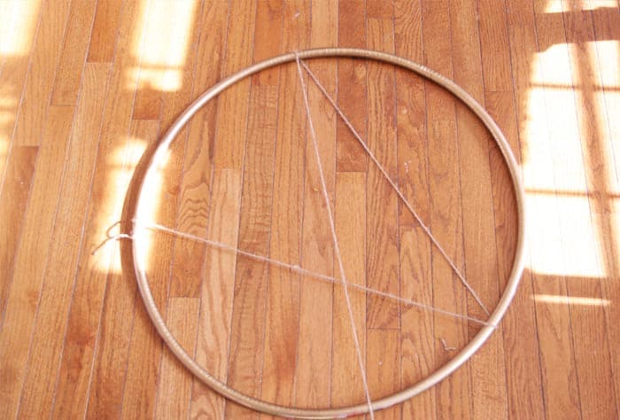 Make a giant Christmas wreath out of a hula hoop and eucalyptus for some rustic and modern holiday decor!