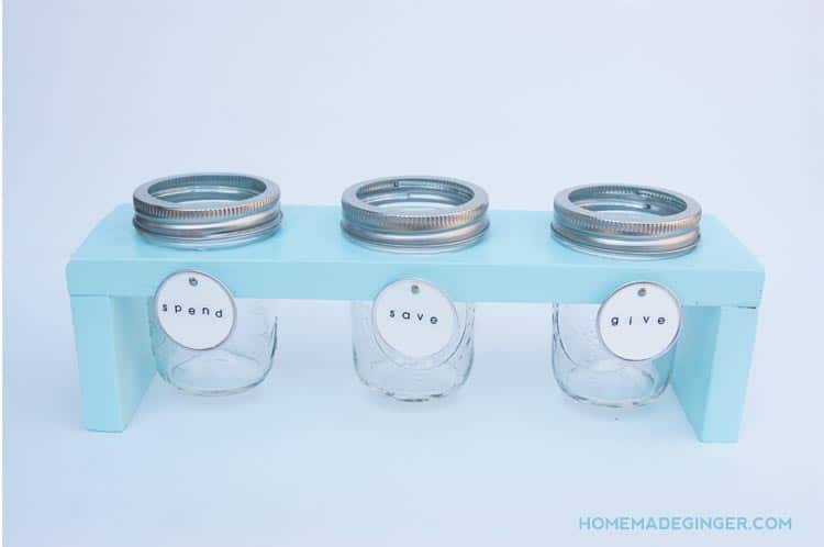 This DIY piggy bank is easy to make even if you don't have much DIY experience. We will show you how to create a wooden stand for 3 mason jars.