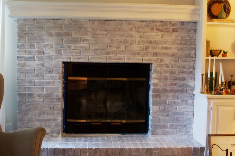 Learn how to update a brick fireplace with just a little work! This fireplace makeover is clean and modern!