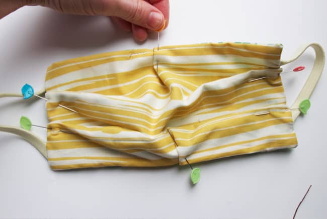 Learn how to sew a face mask using headbands. There is a shortage and elastic and masks with ties are difficult to wash, so use this tutorial to learn how to sew a face mask without elastic!